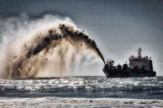 Dredger pumping sand and water to shore for beach renourishment, Mermaid Beach, Gold Coast, Australia, Aug. 20, 2017. Steve Austin, CC BY-SA